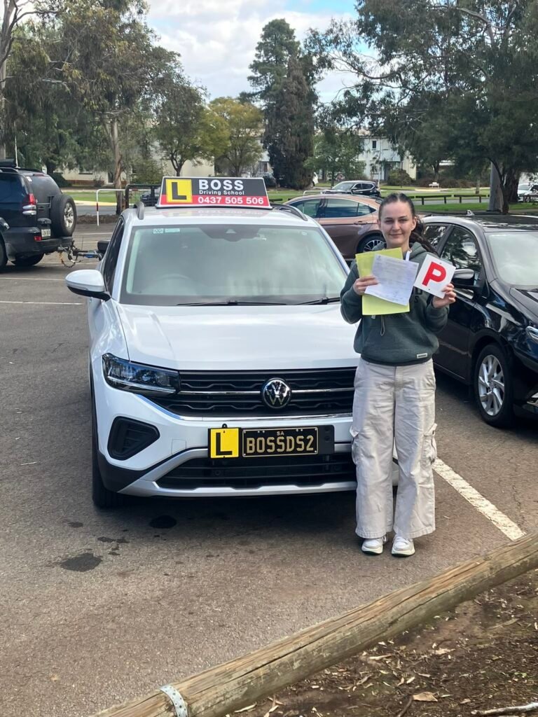 A Boss Driving School student celebrating their driving test pass
