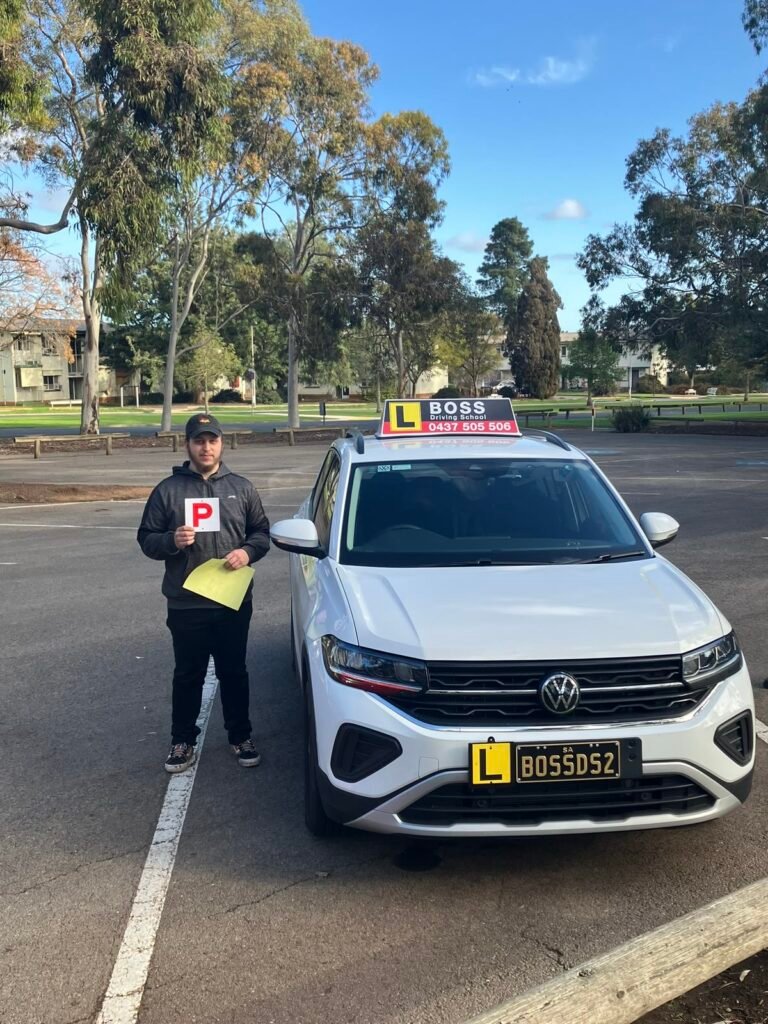 A Boss Driving School student celebrating their driving test pass