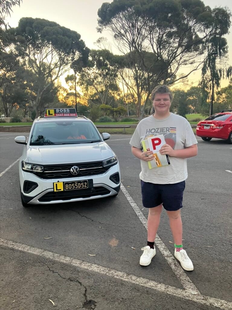 A Boss Driving School student celebrating their driving test pass