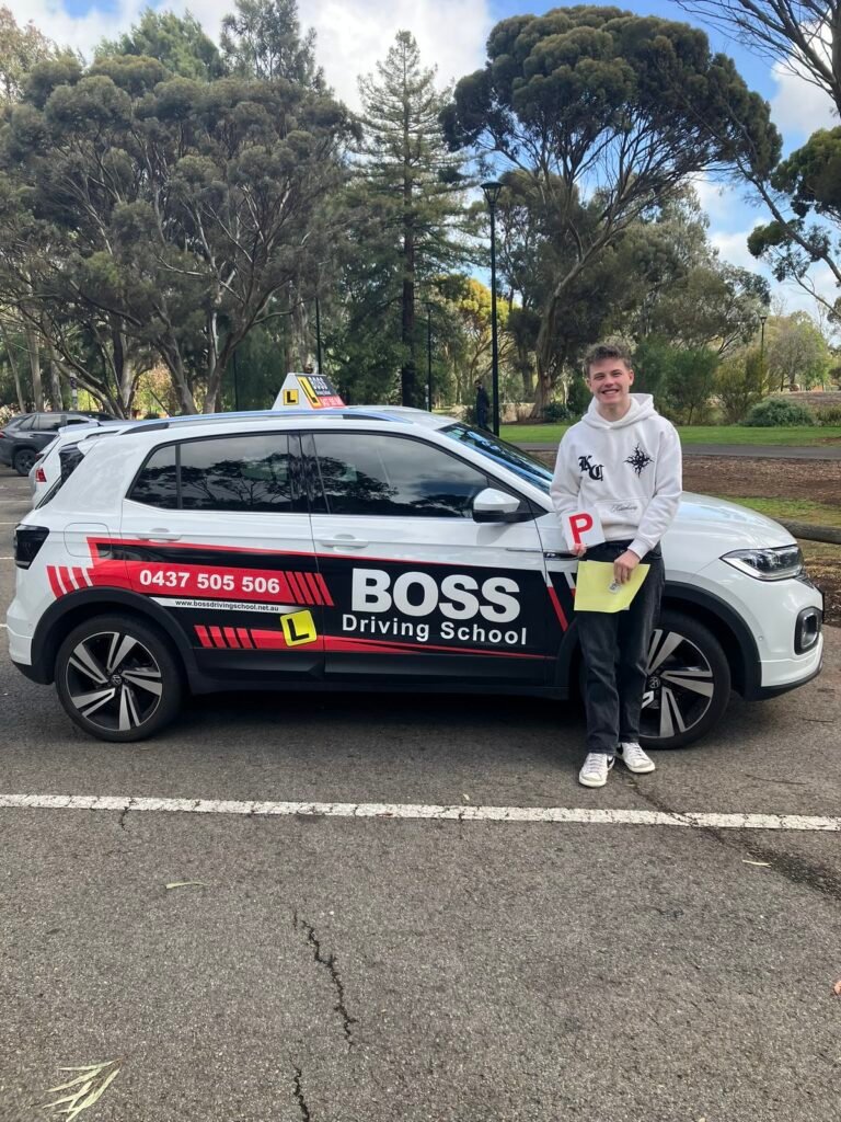 A Boss Driving School student celebrating their driving test pass