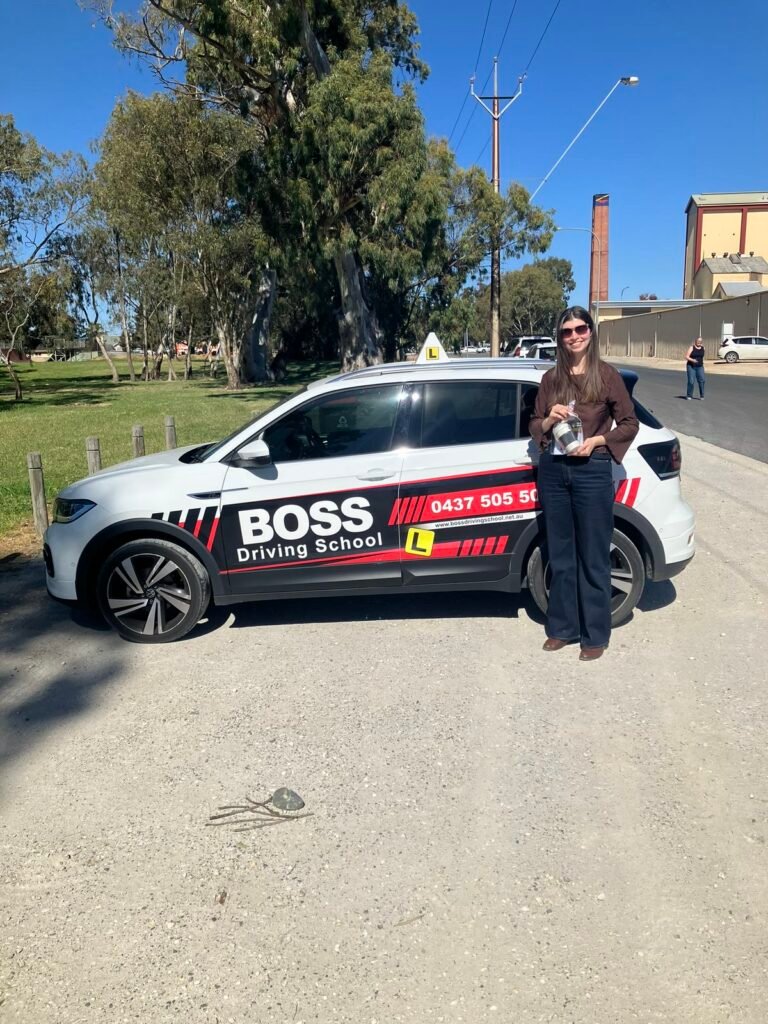 A Boss Driving School student celebrating their driving test pass