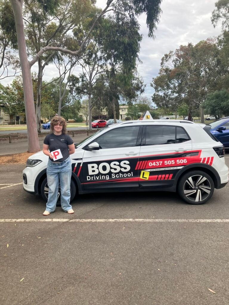 A Boss Driving School student celebrating their driving test pass