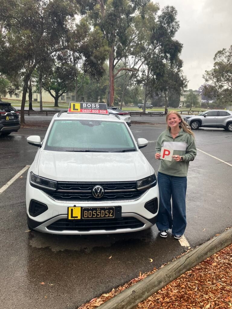 A Boss Driving School student celebrating their driving test pass