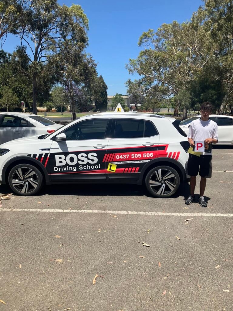 A Boss Driving School student celebrating their driving test pass