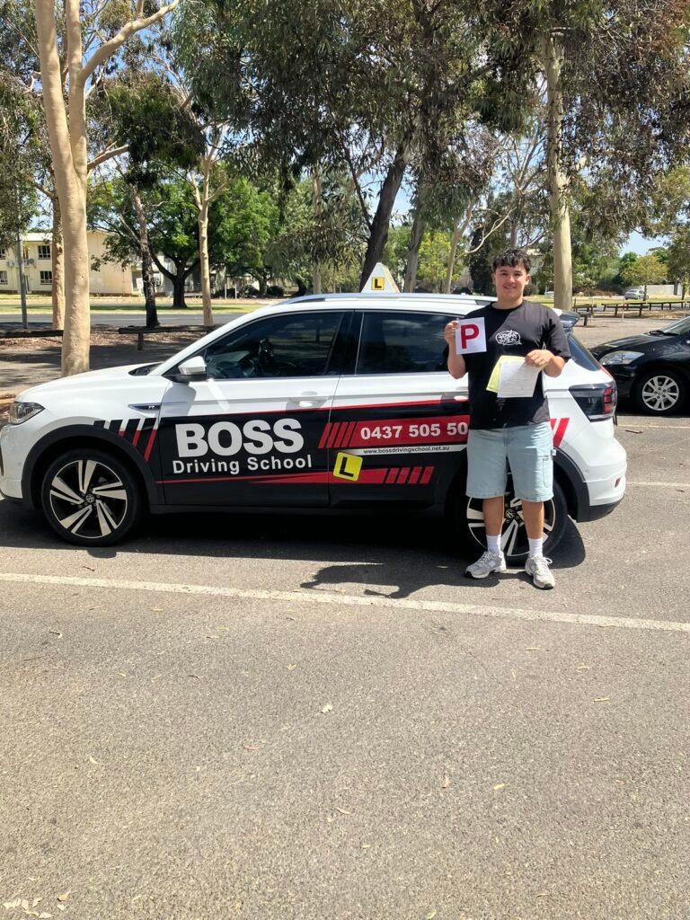A Boss Driving School student celebrating their driving test pass