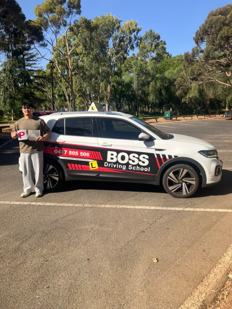 A Boss Driving School student celebrating their driving test pass