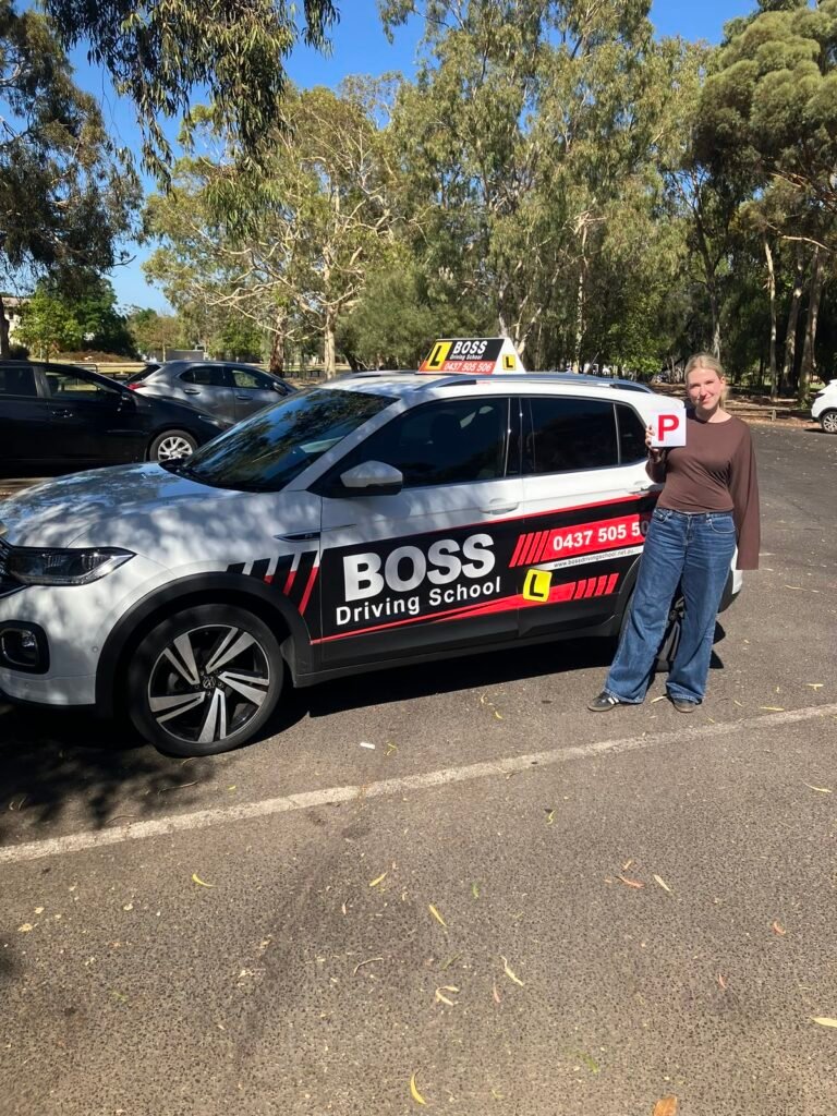 A Boss Driving School student celebrating their driving test pass