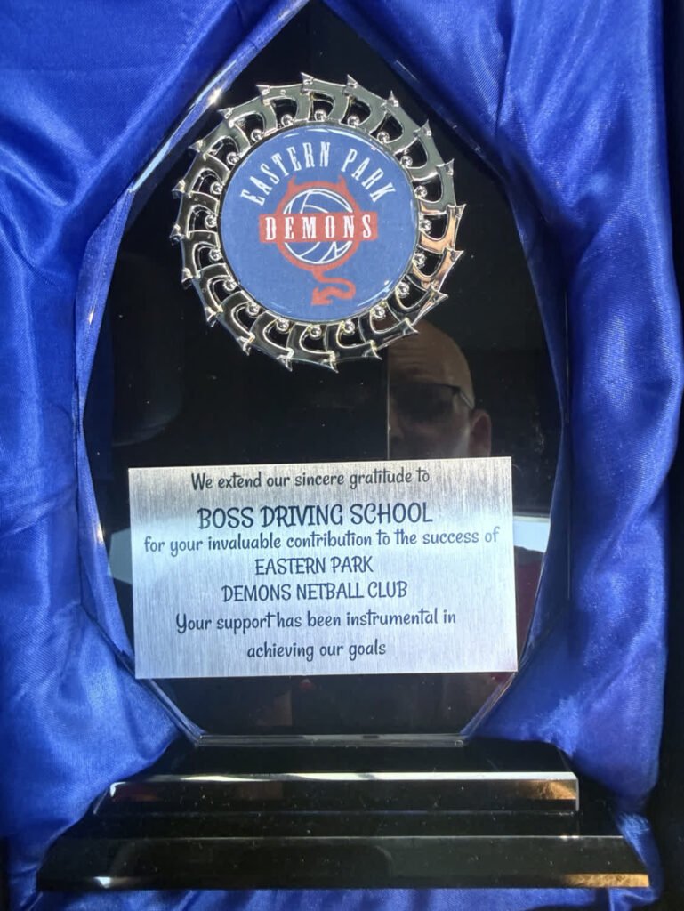 Eastern Park Demons Netball Club thanking Boss Driving School for its support